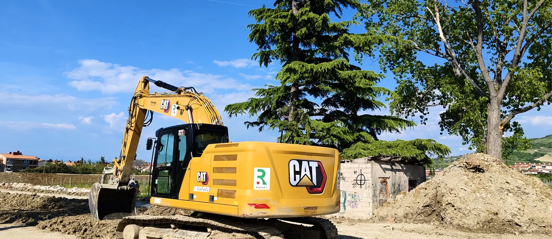 Excavator working on a construction site under a blue sky