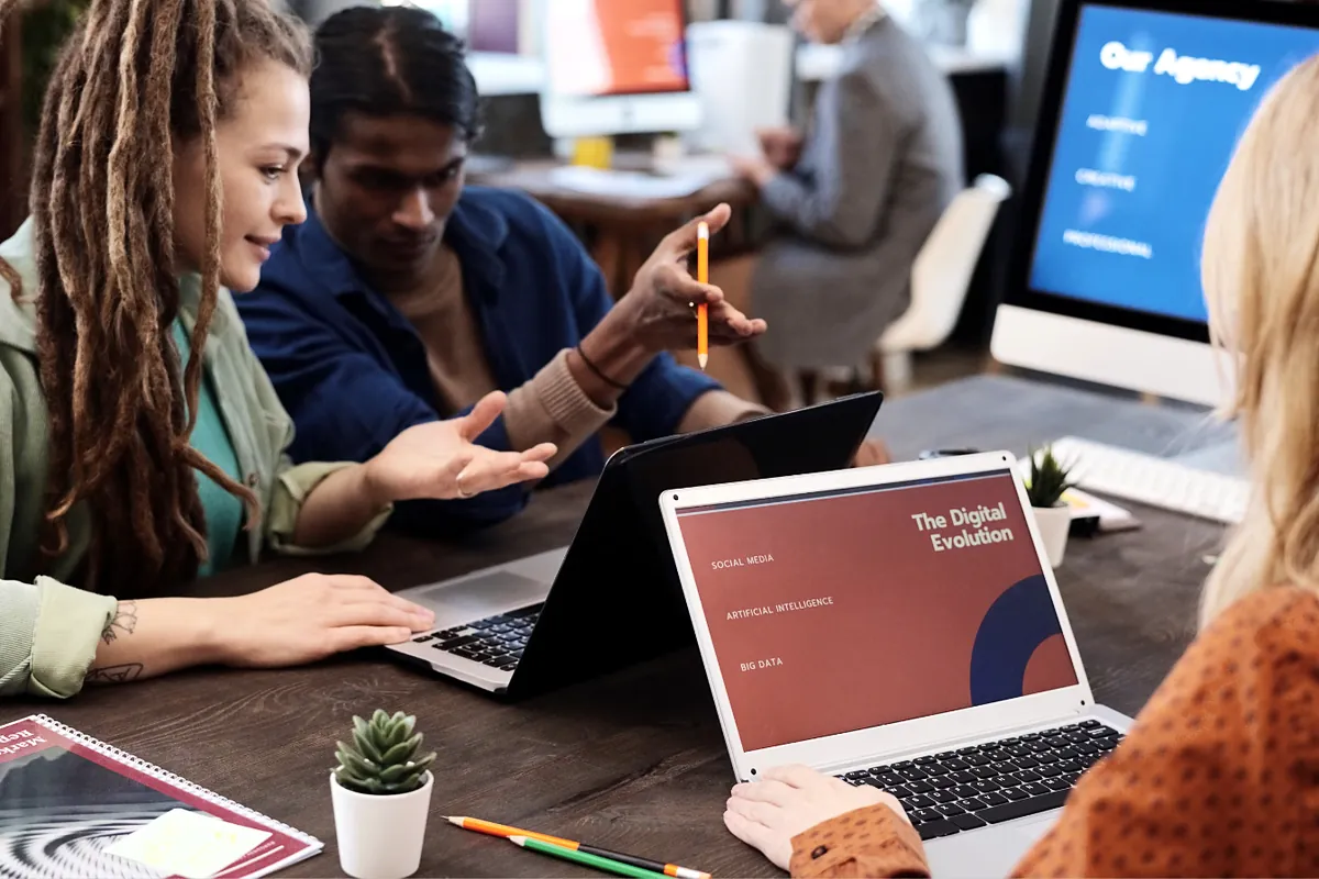 Agency team reviewing a client presentation together on laptops