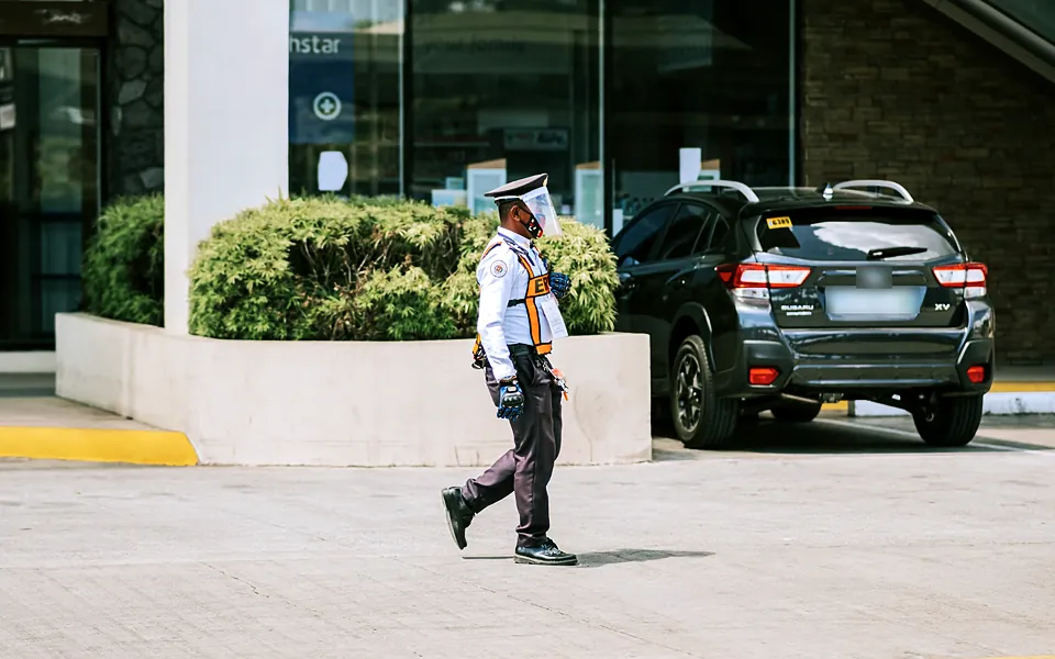 Uniformed security officer on patrol outside a commercial building