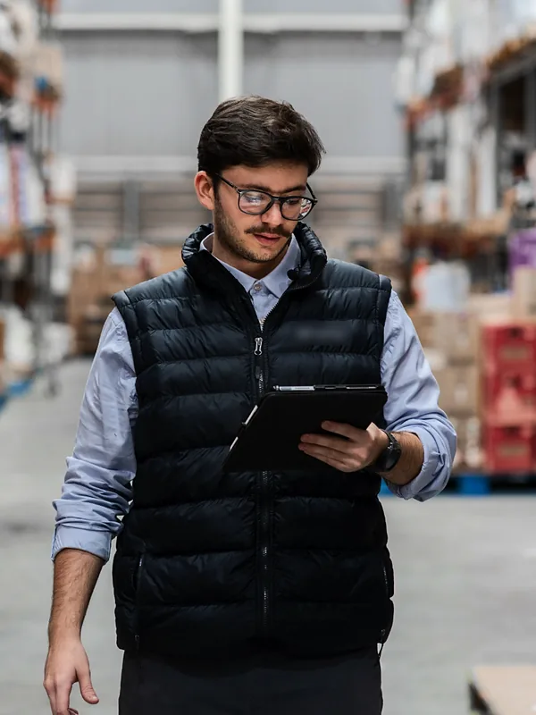 Warehouse manager checking inventory on a tablet